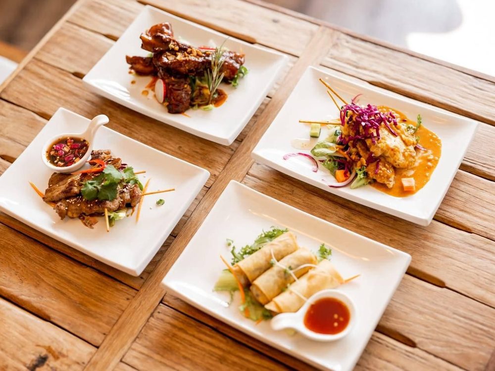 Four starter plates including satay, dumplings and salt and pepper squid