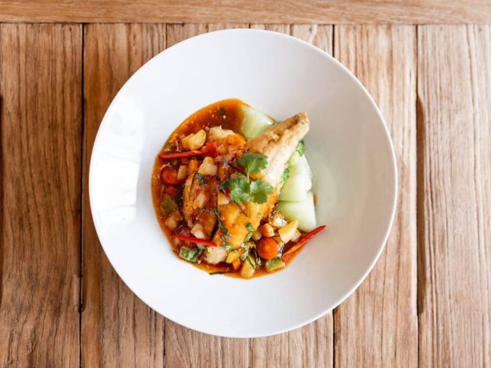 Chilli and basil stir-fry served in a white bowl